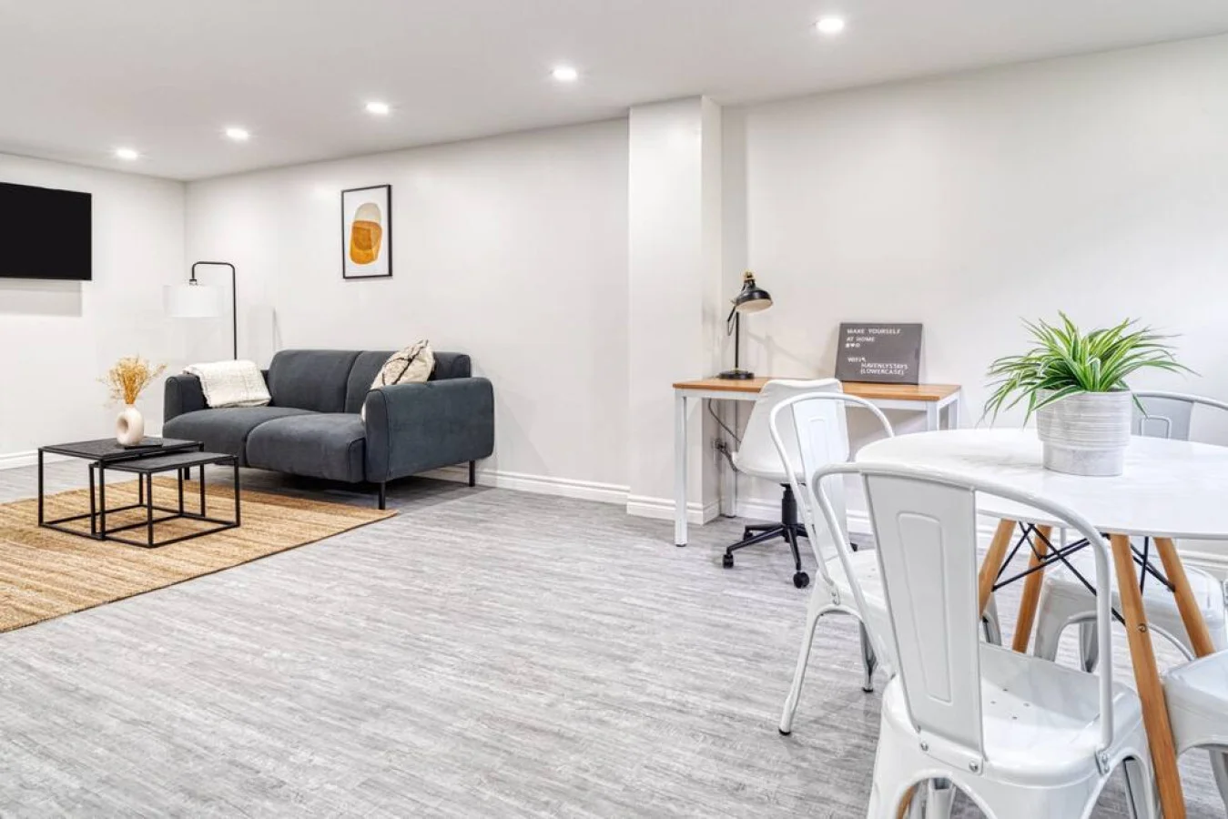 Spacious open-concept living and dining area featuring a vibrant sofa, modern furnishings, and a stylish entertainment setup—ideal for gatherings and relaxation.