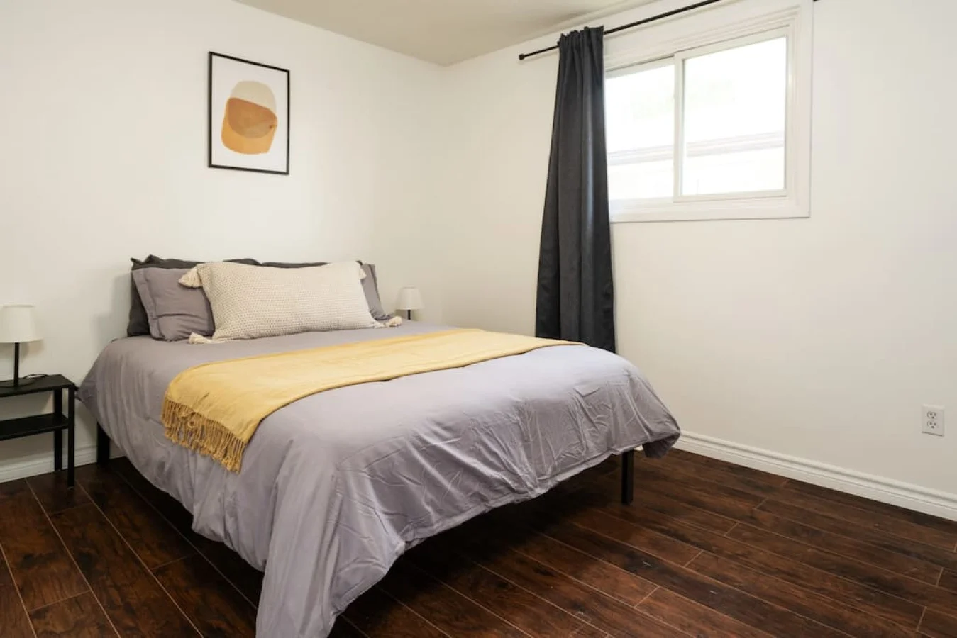 The bedroom’s serene ambiance invites you to relax, with a plush bed that promises a restful night's sleep.