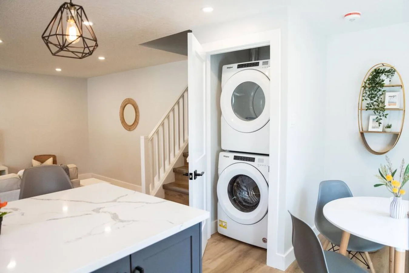 As you step into the laundry room, the modern appliances and ample storage space make it easy to keep things tidy.