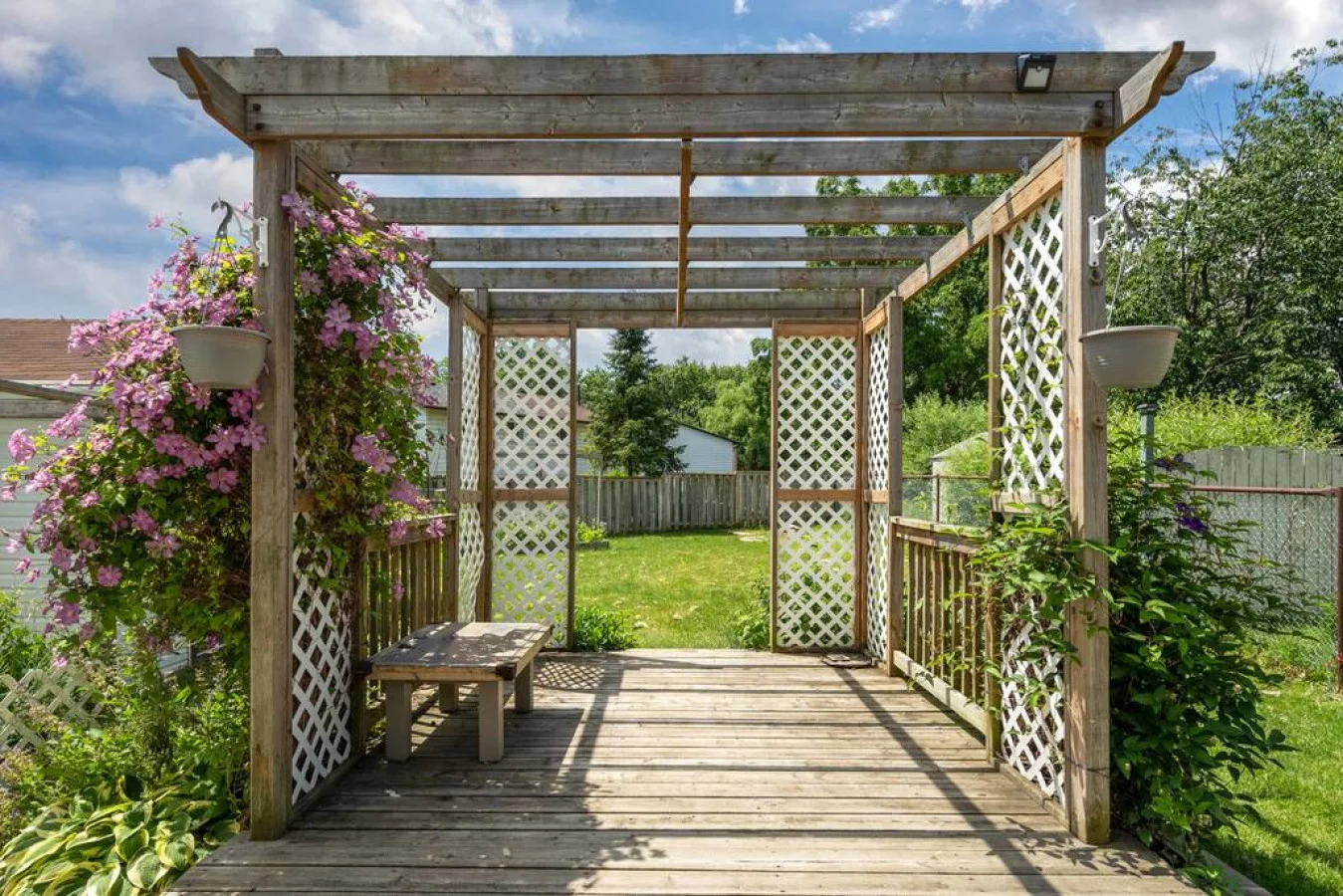 The backyard porch is filled with natural light, creating a bright and welcoming space that invites relaxation.
