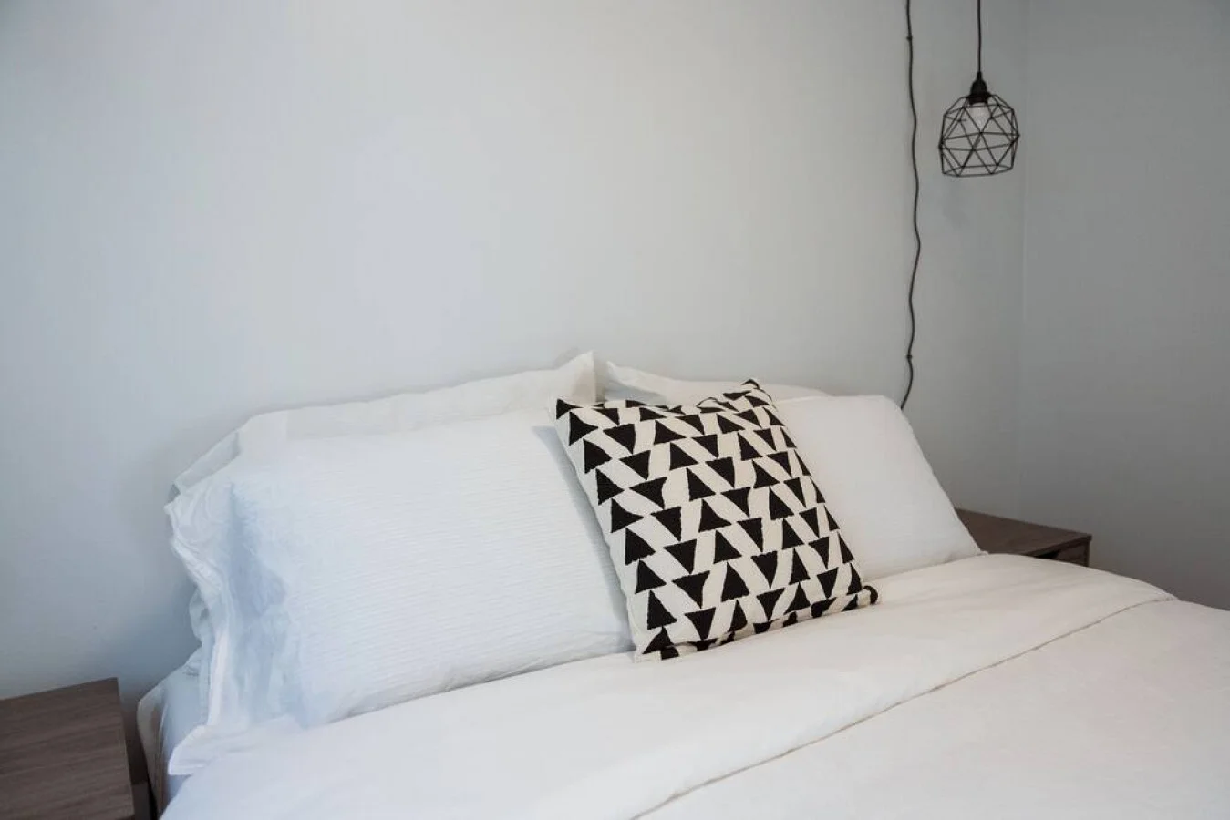 You feel enveloped in comfort as you relax on the queen bed, surrounded by a room designed for tranquility.