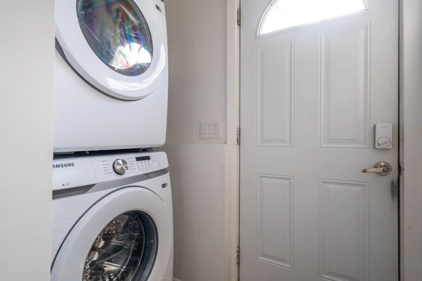 As you step into the laundry room, the modern appliances and ample storage space make it easy to keep things tidy.