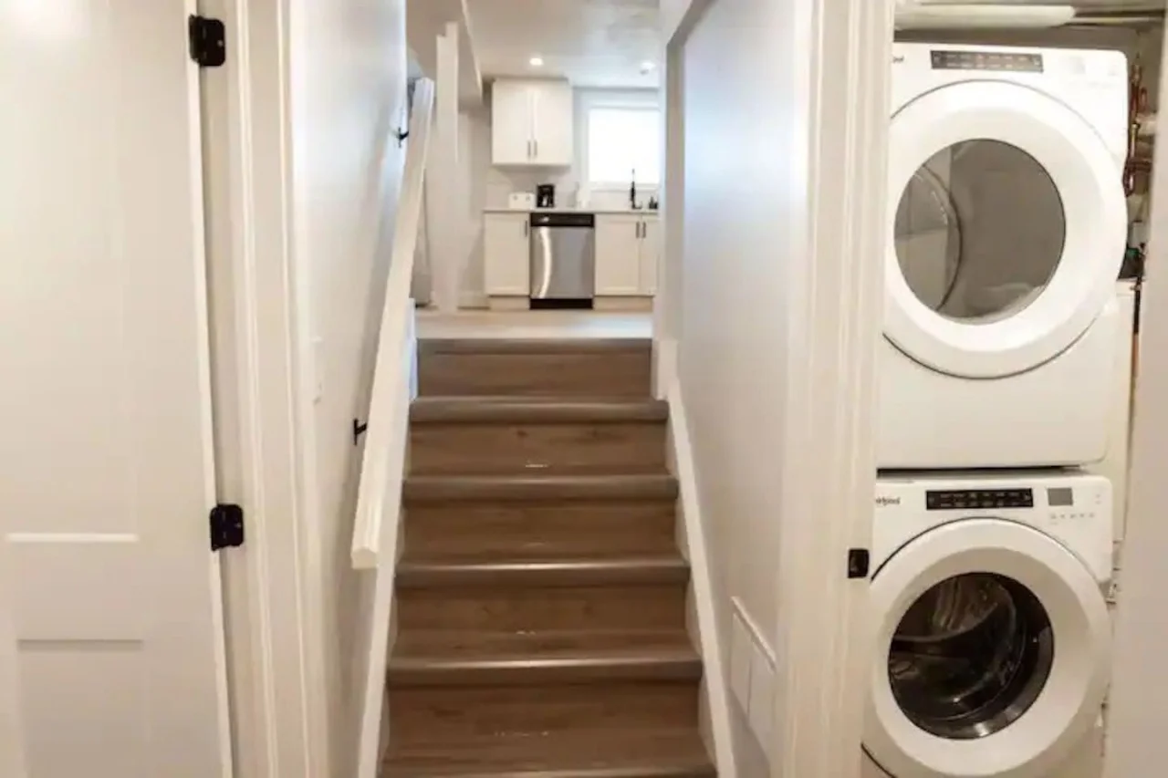 As you step into the laundry room, the modern appliances and ample storage space make it easy to keep things tidy.