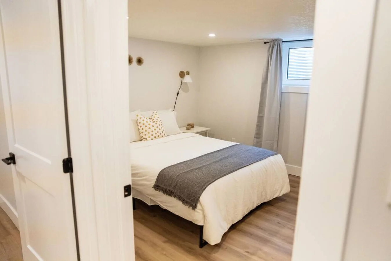You feel enveloped in comfort as you relax on the queen bed, surrounded by a room designed for tranquility.
