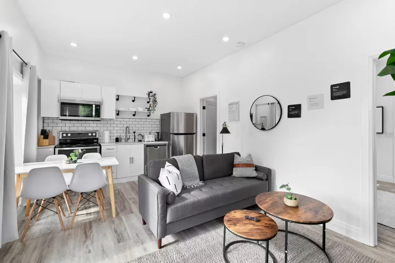 Spacious open-concept living and dining area featuring a vibrant sofa, modern furnishings, and a stylish entertainment setup—ideal for gatherings and relaxation.