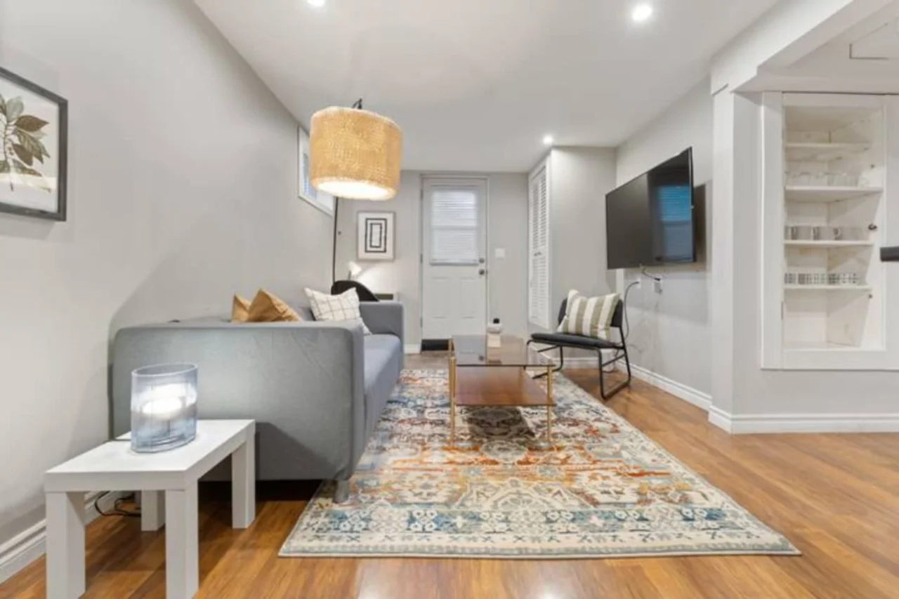 Relax in this warm, inviting space with wooden accents and cozy furnishings. You’ll love unwinding on the plush sofa, enjoying a good book or streaming your favorite shows in a serene atmosphere