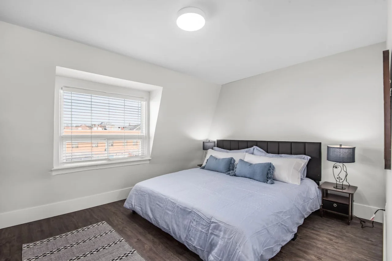 Luxurious bedroom featuring a comfortable bed, elegant decor, and plenty of natural light for a rejuvenating sleep.
