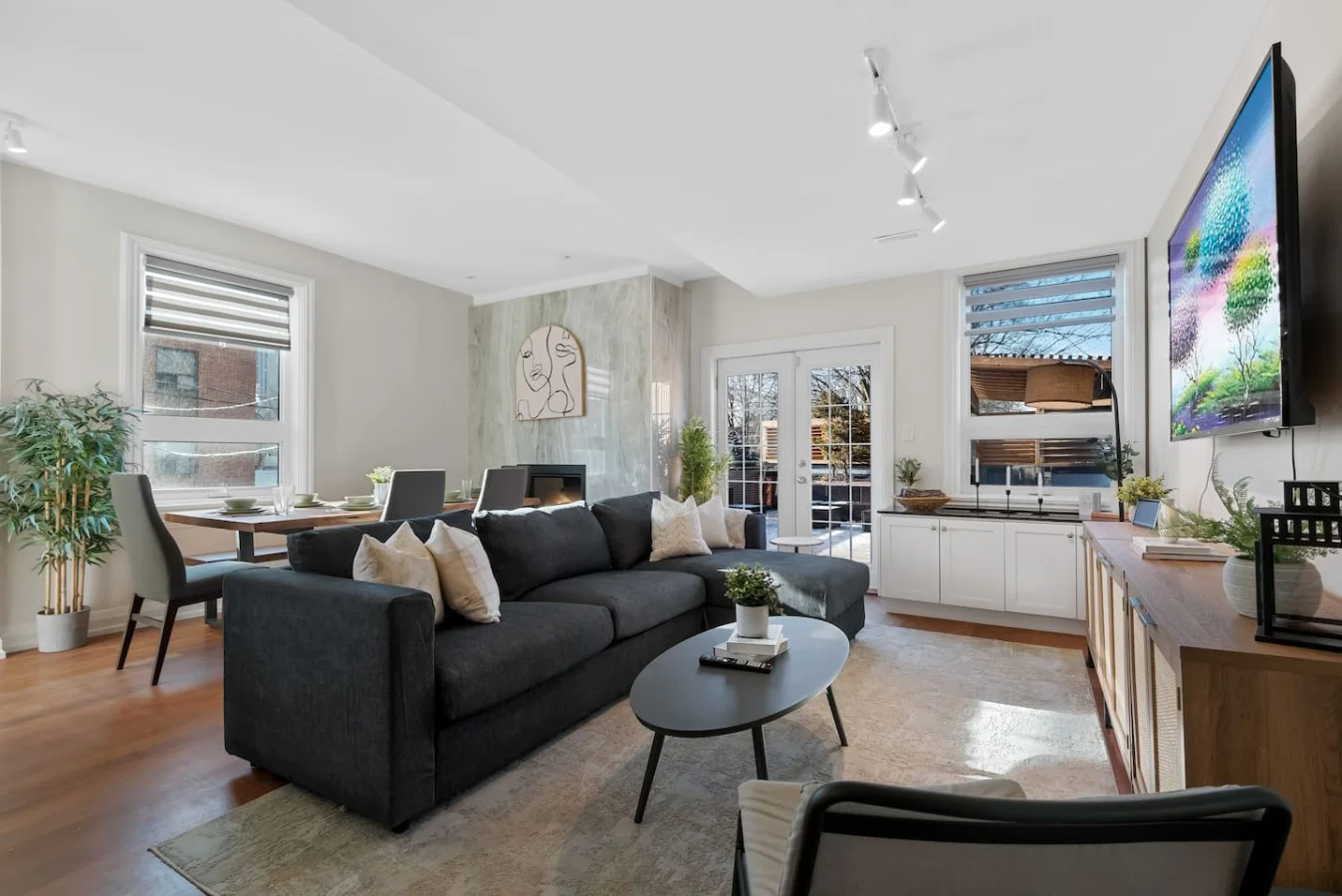 The living room is filled with natural light, creating a bright and welcoming space that invites relaxation.