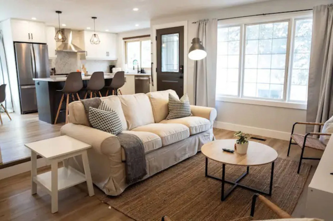 The living room is filled with natural light, creating a bright and welcoming space that invites relaxation.