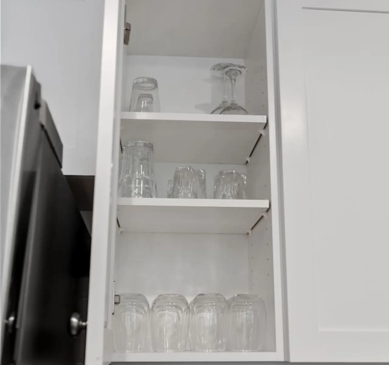 Kitchen cabinets stocked with cooking wares, glassware and silverwares, ideal for mixing up your favorite meals and drinks during your stay.