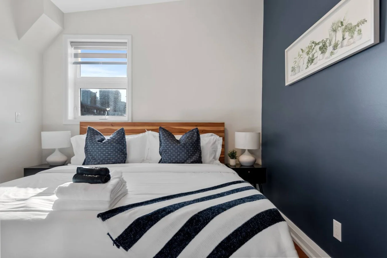 The bedroom offers a luxurious retreat, with a bed that promises restful nights and a room that feels like a private oasis.