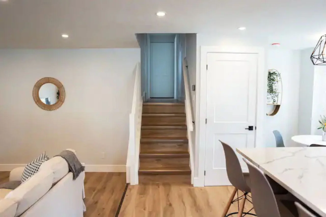 The staircase is a focal point of the home, with its graceful lines and stylish details adding to the overall charm.