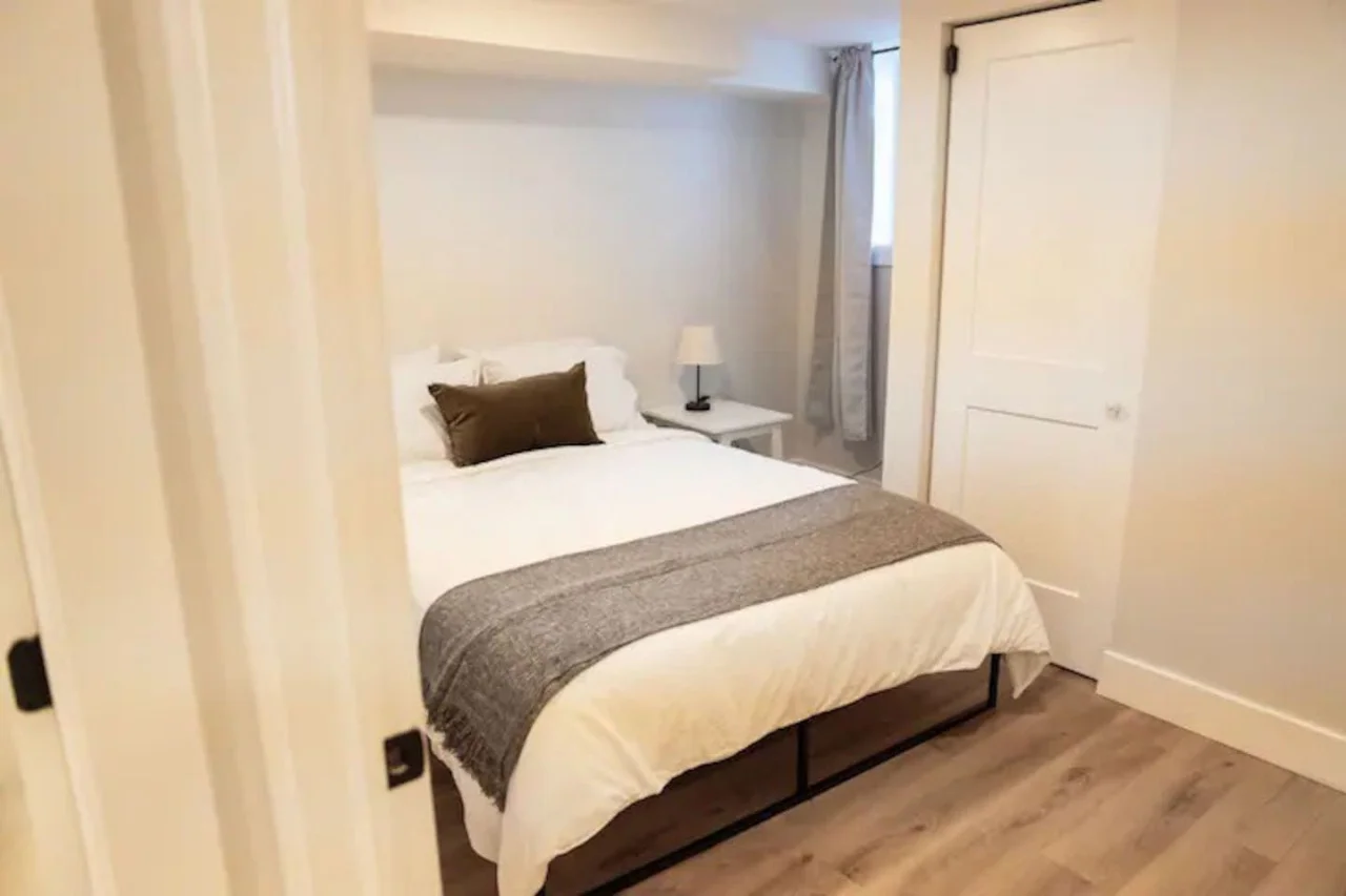 The bedroom offers a luxurious retreat, with a bed that promises restful nights and a room that feels like a private oasis.