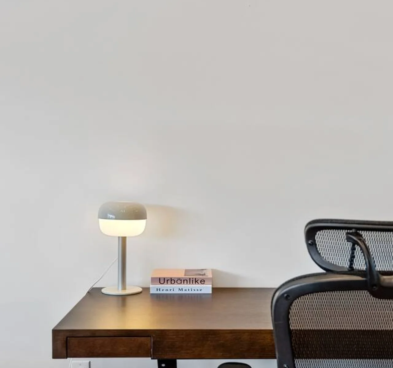 This cozy workspace with warm lighting, and a creative wall display, perfect for productivity.