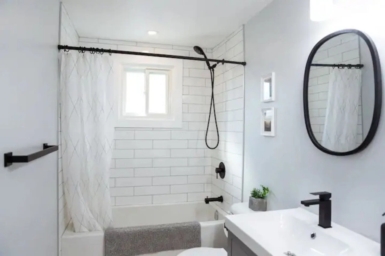 Immaculate bathroom featuring a spacious shower, fresh towels, and complimentary toiletries for a spa-like experience.