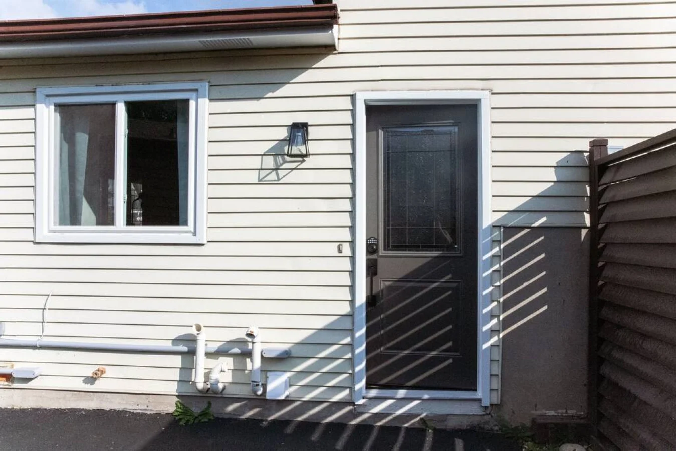 As you approach the house, the inviting entrance and beautiful exterior make you eager to explore what’s inside.