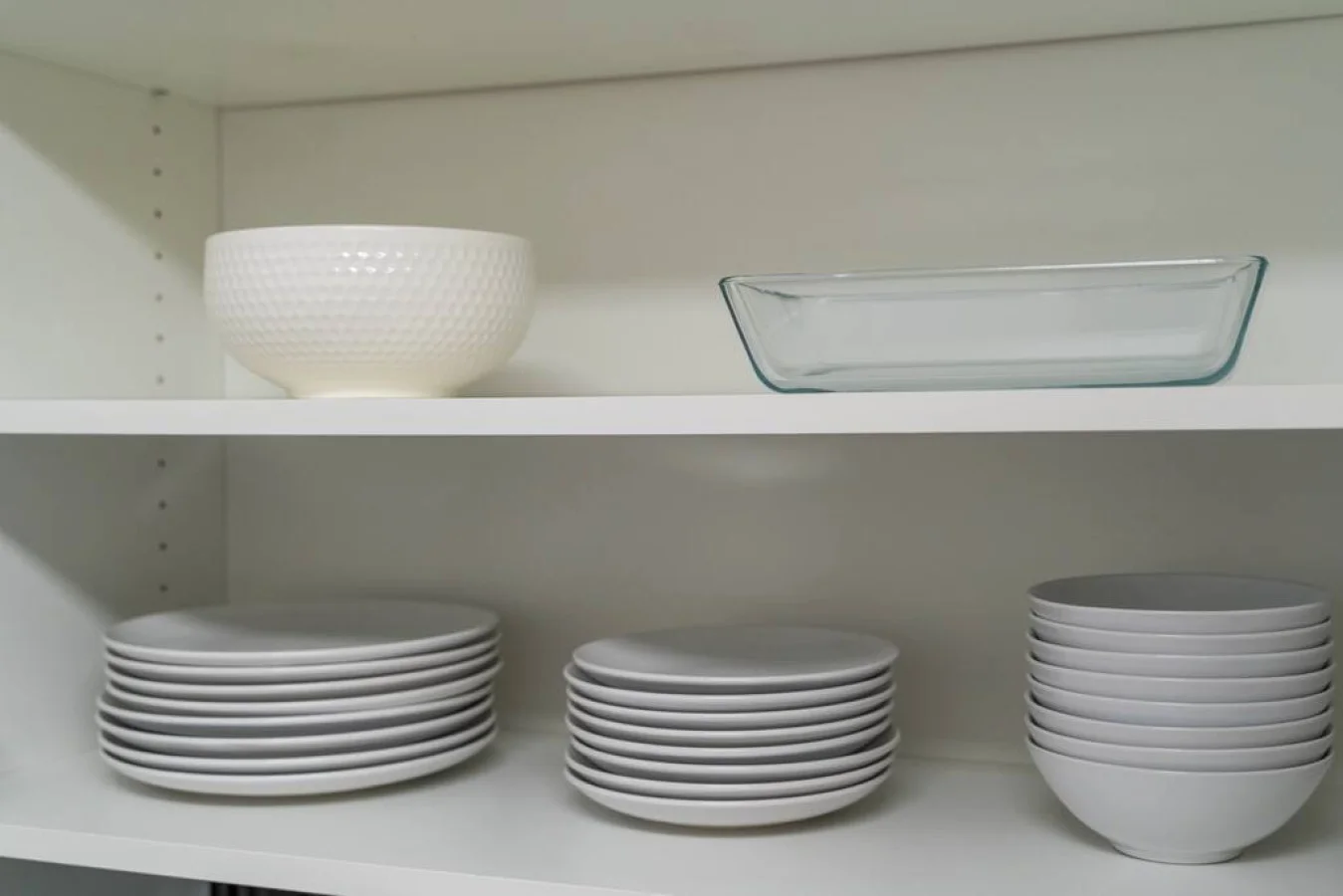 Kitchen cabinets stocked with cooking wares, glassware and silverwares, ideal for mixing up your favorite meals and drinks during your stay.