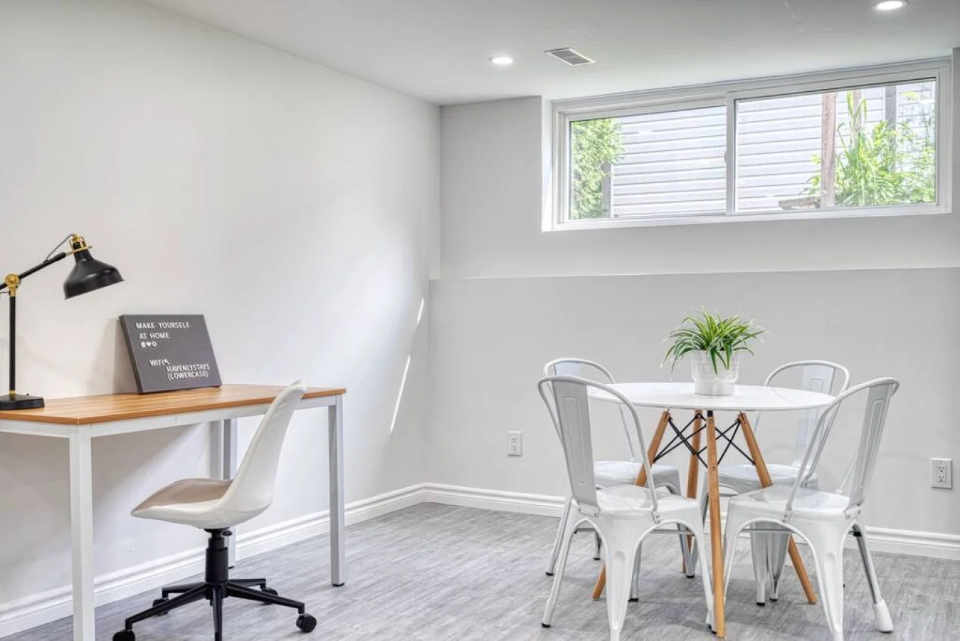 This cozy workspace with warm lighting, and a creative wall display, perfect for productivity.