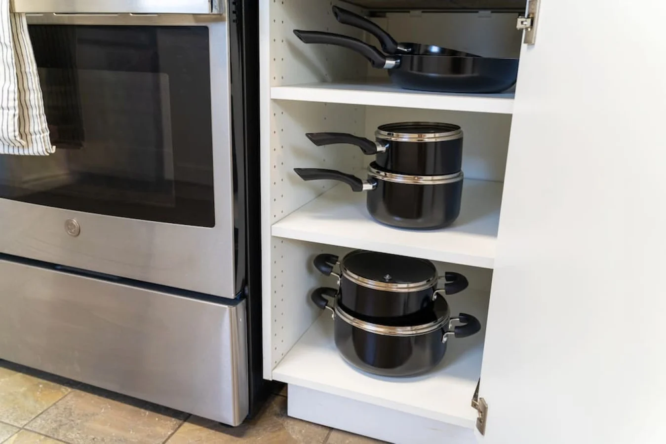 Kitchen cabinets stocked with cooking wares, glassware and silverwares, ideal for mixing up your favorite meals and drinks during your stay.