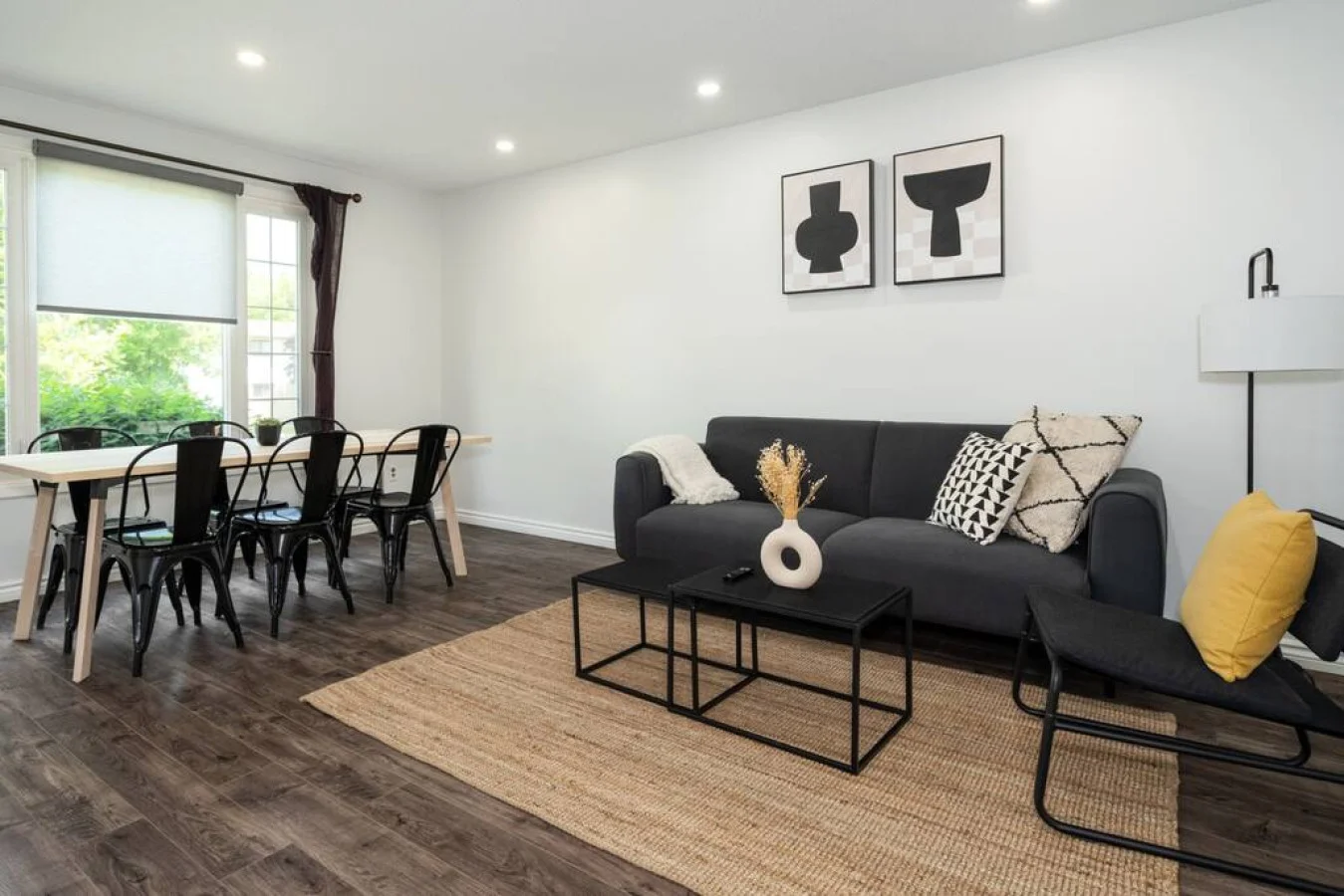 Spacious open-concept living and dining area featuring a vibrant sofa, modern furnishings, and a stylish entertainment setup—ideal for gatherings and relaxation.