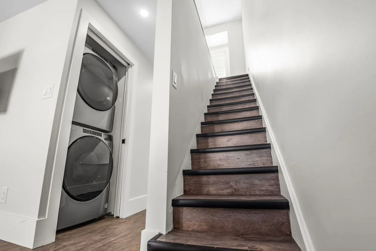 The staircase is a focal point of the home, with its graceful lines and stylish details adding to the overall charm.