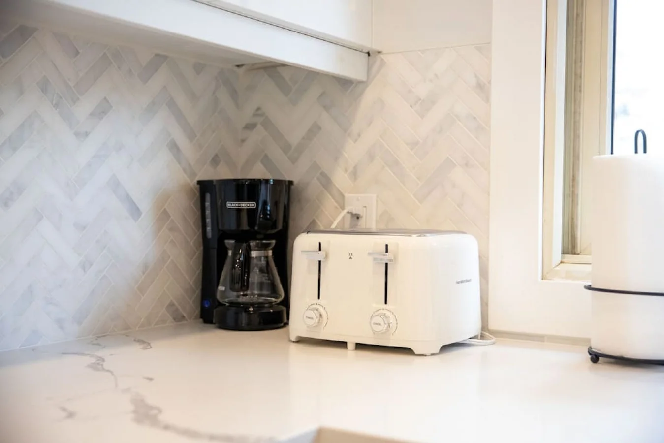 The coffee station is thoughtfully equipped with a variety of in-house consumables, including a selection of ground coffee, sweeteners, and creamers to suit every taste.