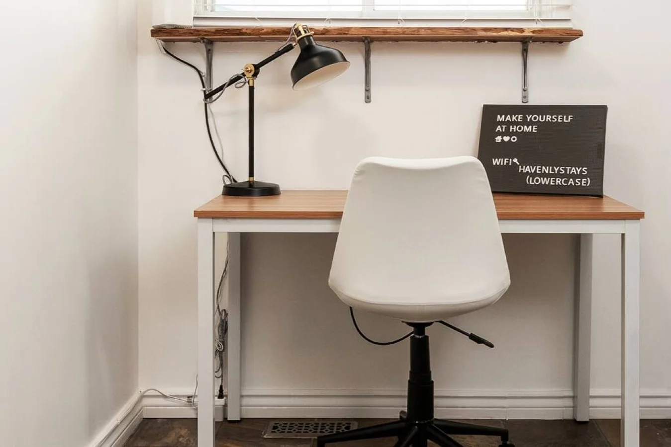This cozy workspace with warm lighting, and a creative wall display, perfect for productivity.