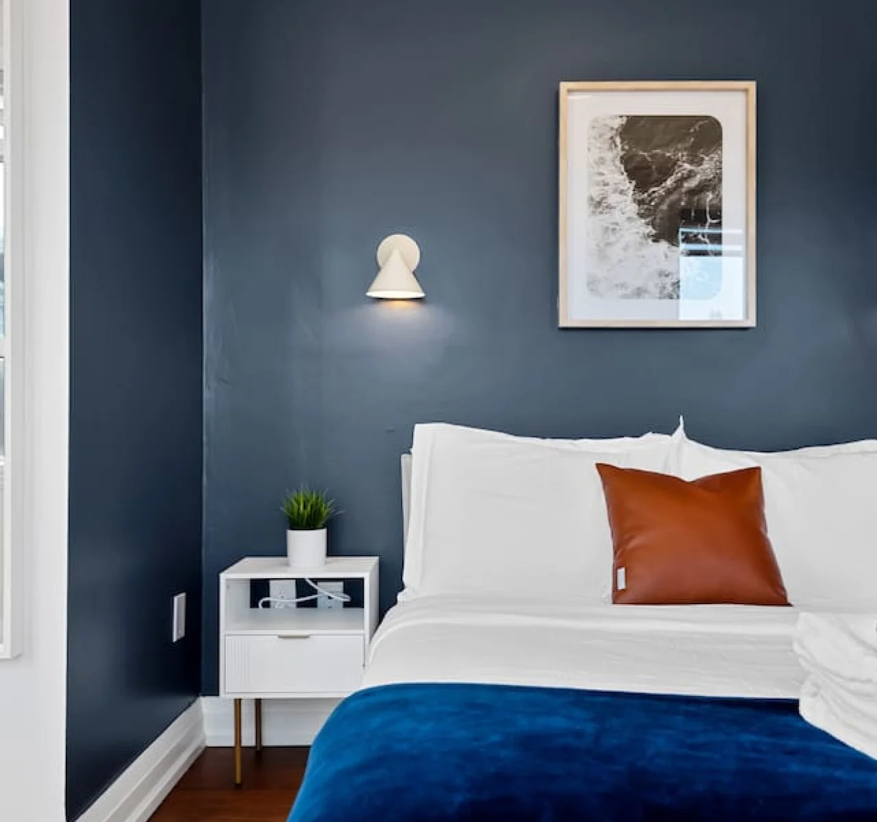 The bedroom offers a luxurious retreat, with a bed that promises restful nights and a room that feels like a private oasis.