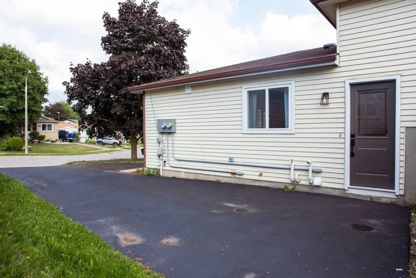 As you approach the house, the inviting entrance and beautiful exterior make you eager to explore what’s inside.
