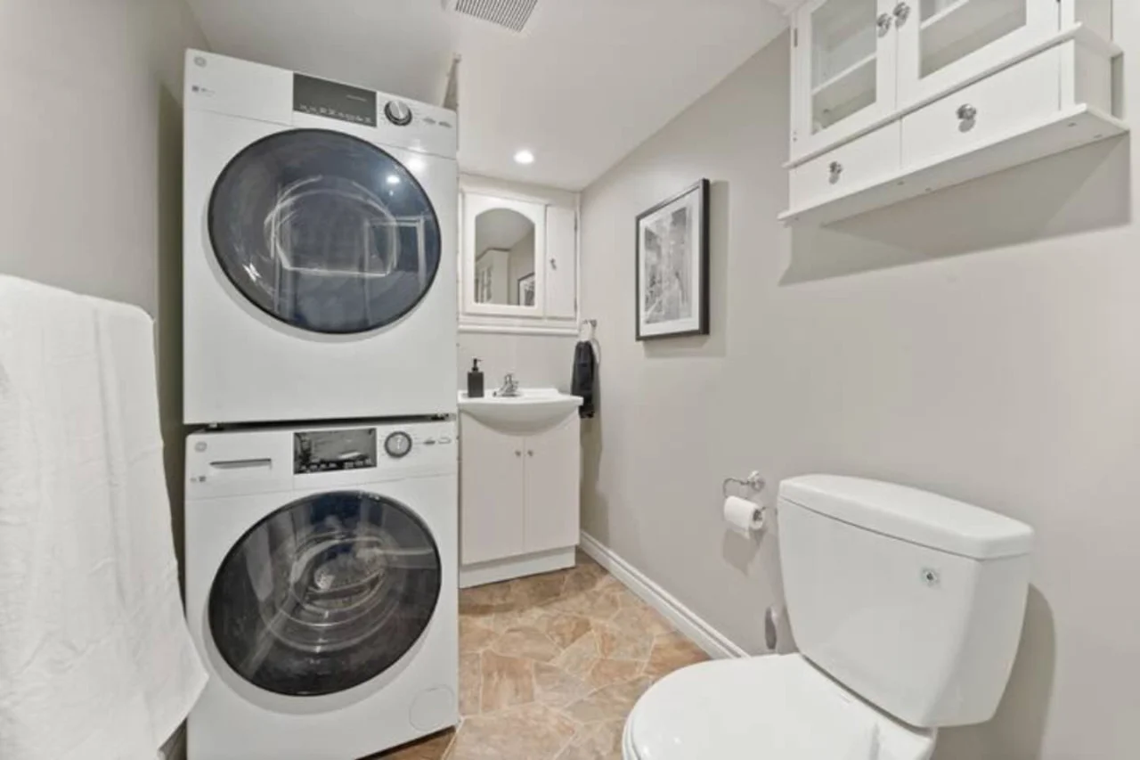 As you step into the laundry room, the modern appliances and ample storage space make it easy to keep things tidy.