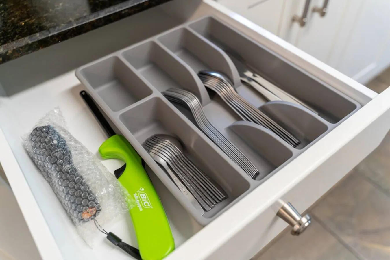 Kitchen utensils with scissors, measuring cups, grater, wine opener, can opener