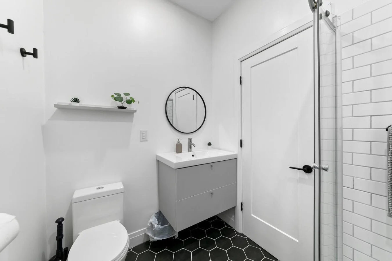 This bright and welcoming bathroom invites you to freshen up in comfort. Enjoy the forest-inspired shower curtain that adds a calming touch to your routine, complemented by the cozy rug underfoot and sparkling clean fixtures.