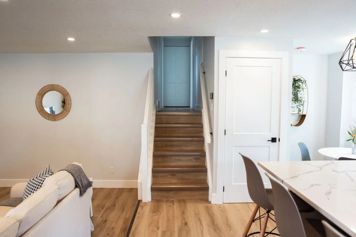 The staircase is a focal point of the home, with its graceful lines and stylish details adding to the overall charm.