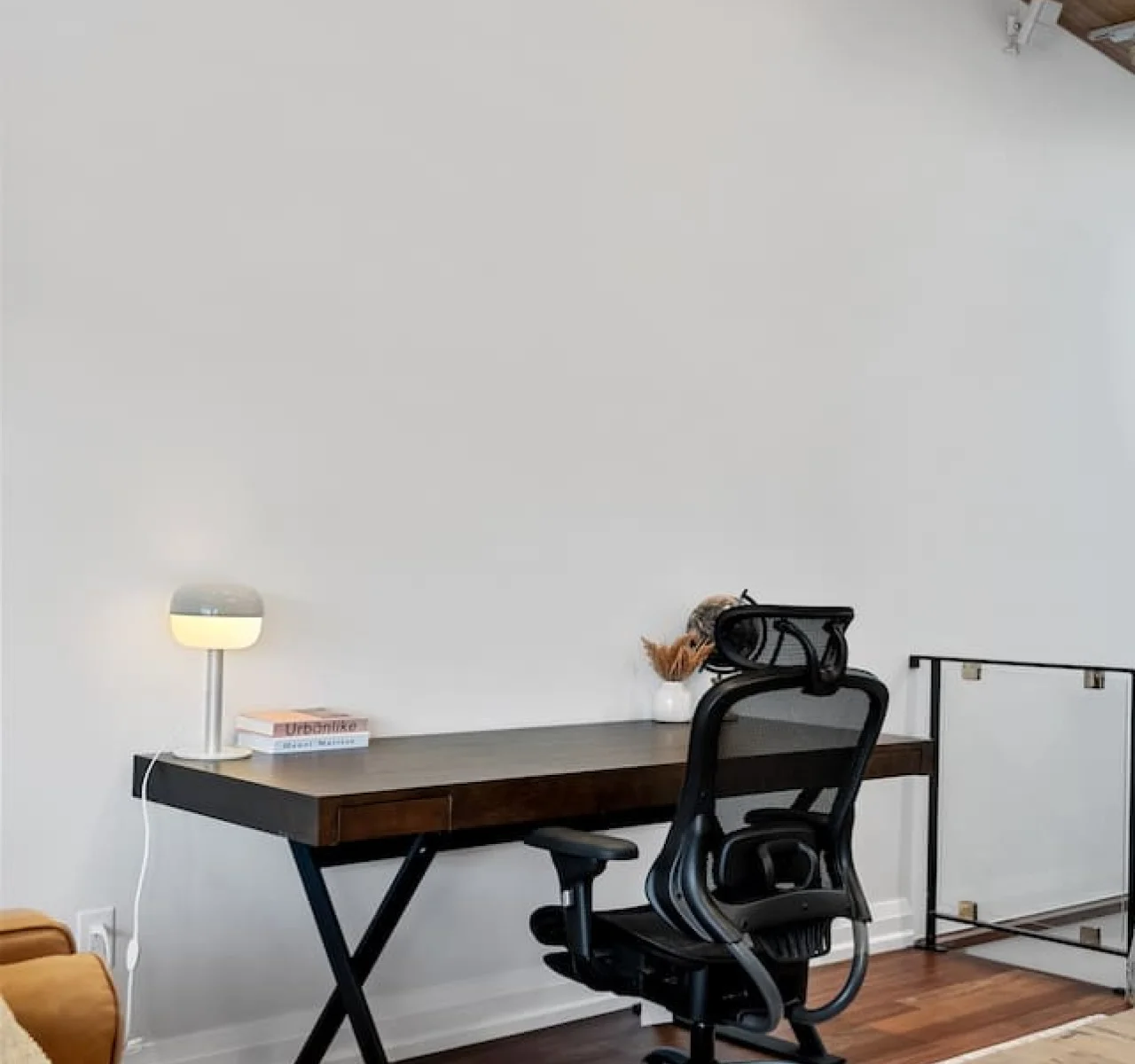 This cozy workspace with warm lighting, and a creative wall display, perfect for productivity.
