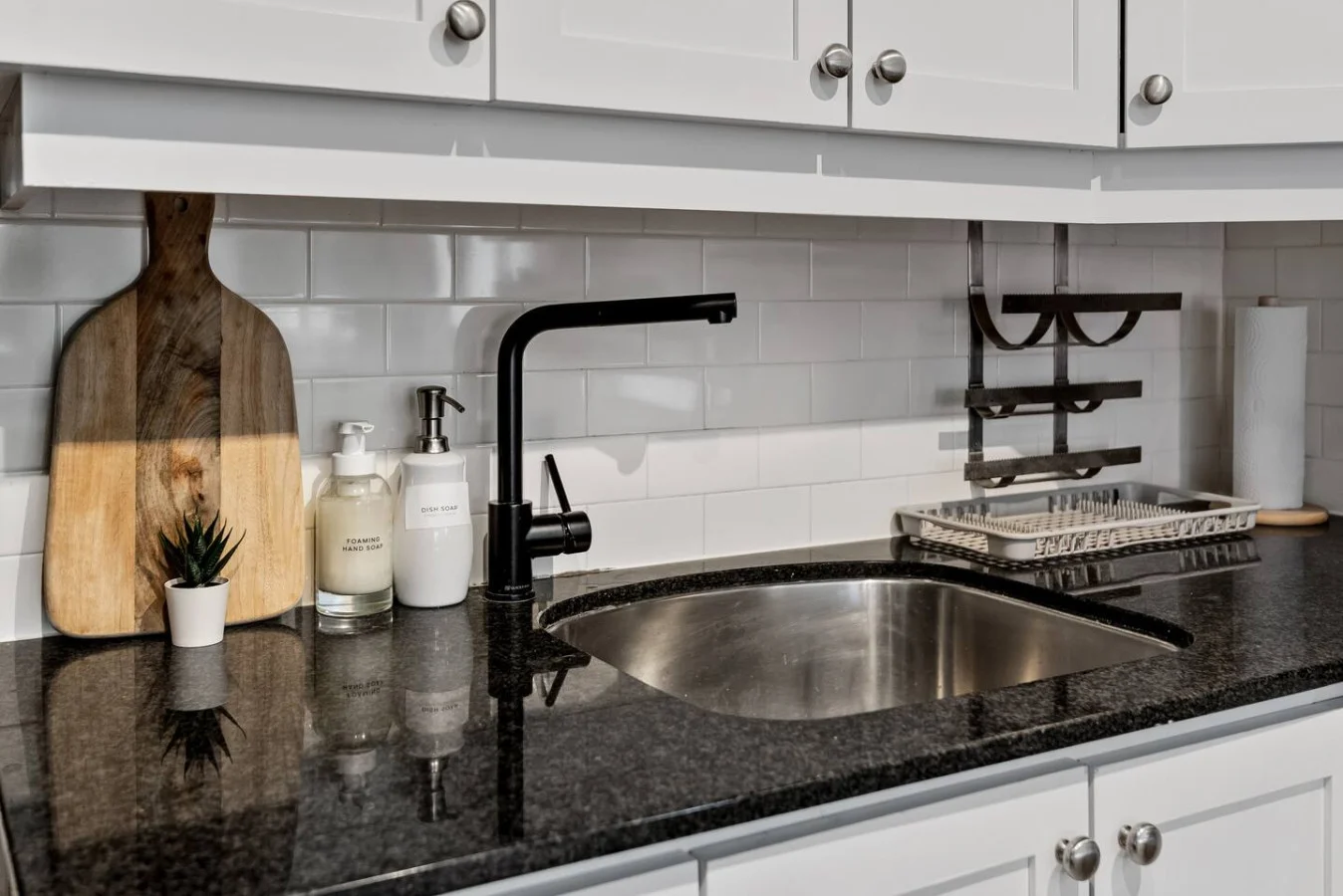 Cook with ease in this well-equipped kitchen featuring stainless steel appliances, ample cabinetry, and a stylish backsplash. Whether you're brewing coffee or preparing a gourmet meal, this space is designed for functionality and style, making every meal