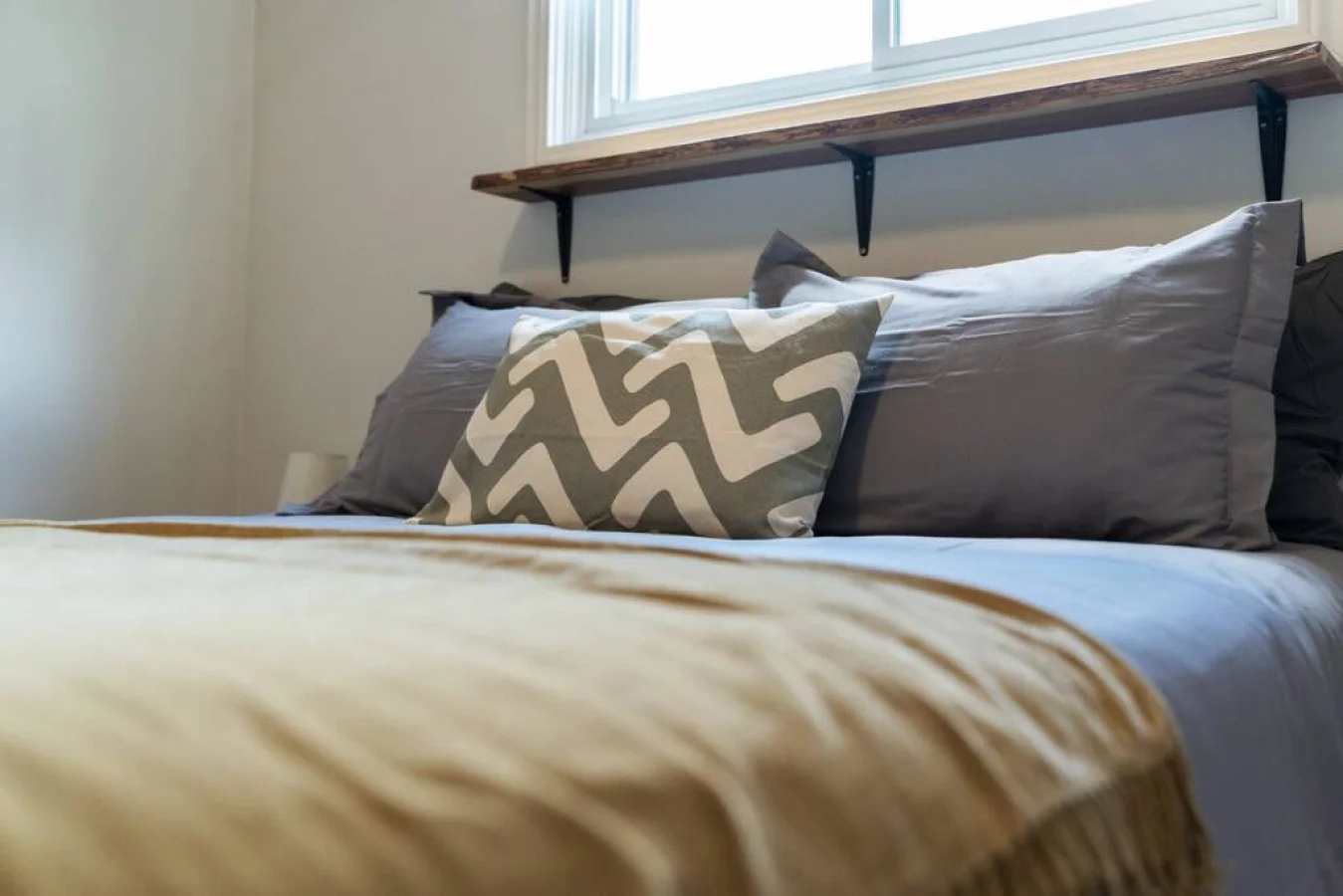 The queen bedroom’s stylish design and comfortable bedding create a perfect sanctuary for restful nights.