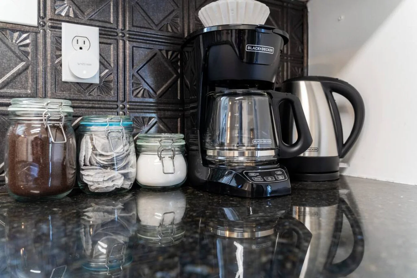 As you open the kitchen, you discover an assortment of coffee pods, and sugar, ensuring you have everything you need for a perfect morning or afternoon pick-me-up.