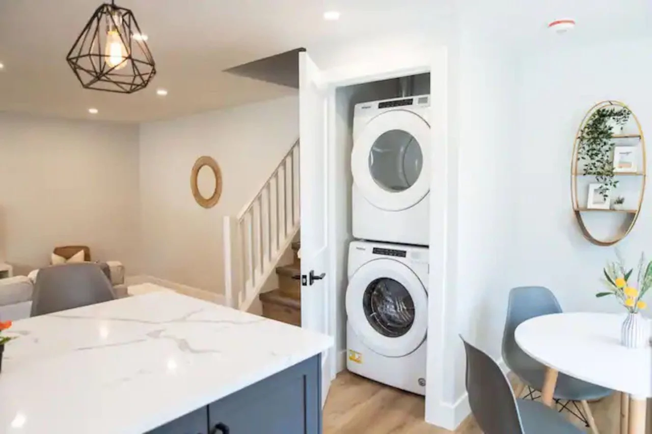 Laundry room with a washer, dryer, and folding area, offering all the convenience you need for a comfortable extended stay.