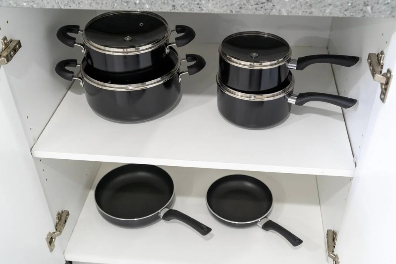 Kitchen cabinets stocked with cooking wares, glassware and silverwares, ideal for mixing up your favorite meals and drinks during your stay.