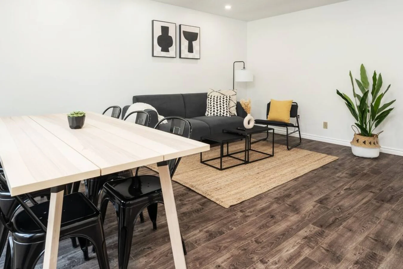 Spacious open-concept living and dining area featuring a vibrant sofa, modern furnishings, and a stylish entertainment setup—ideal for gatherings and relaxation.
