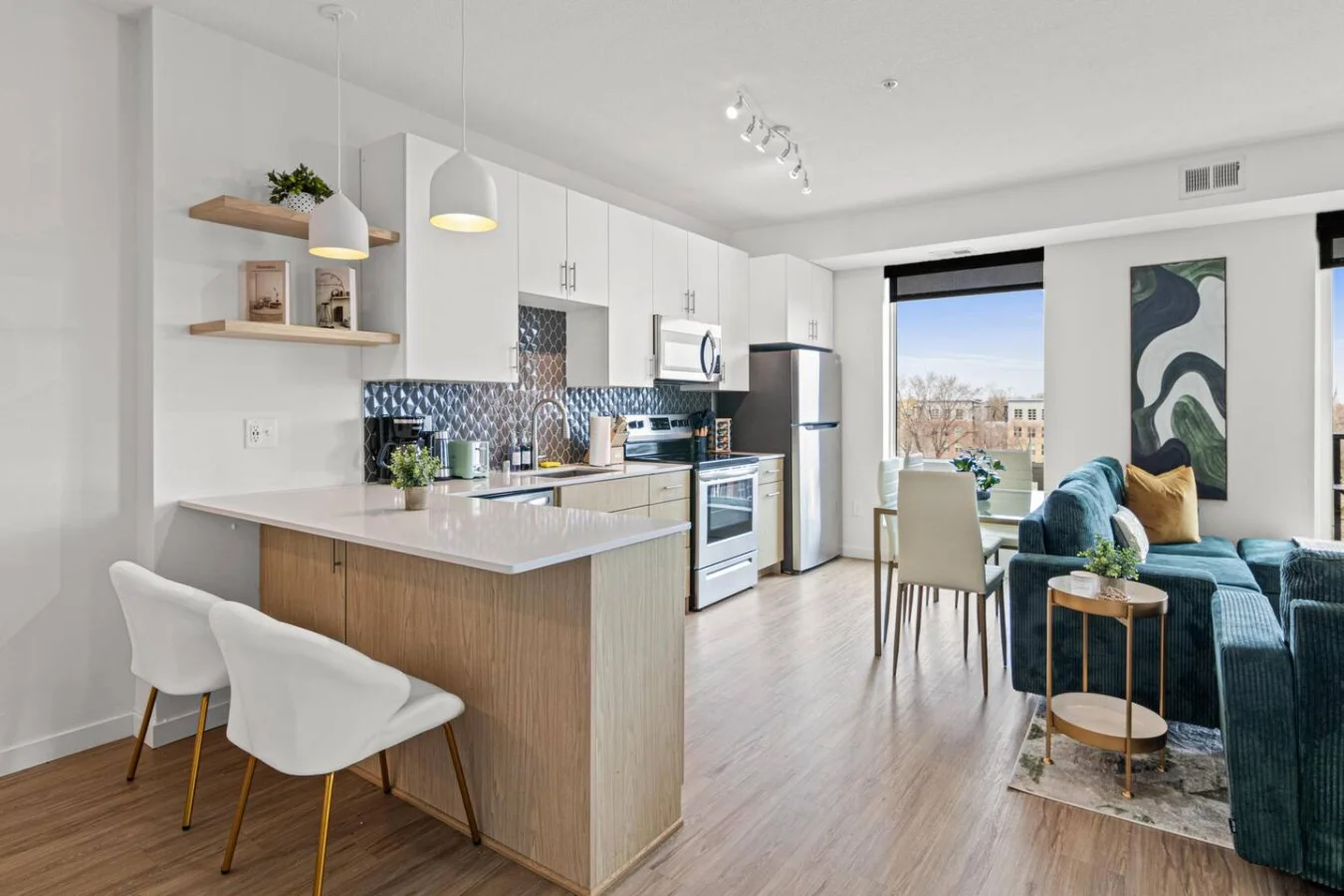Spacious open-concept living and dining area featuring a vibrant sofa, modern furnishings, and a stylish entertainment setup—ideal for gatherings and relaxation.