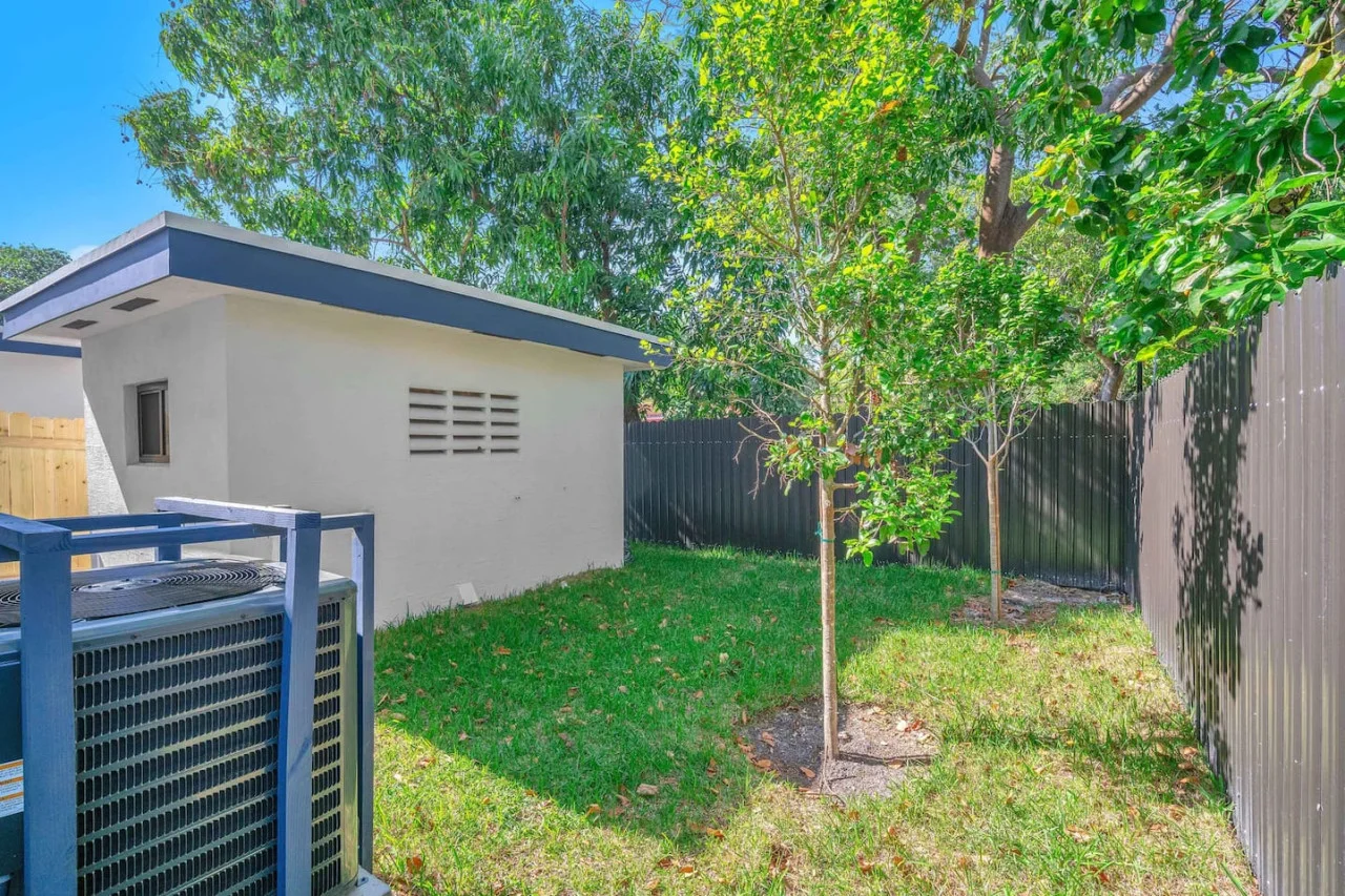 Fenced yard with trees.
