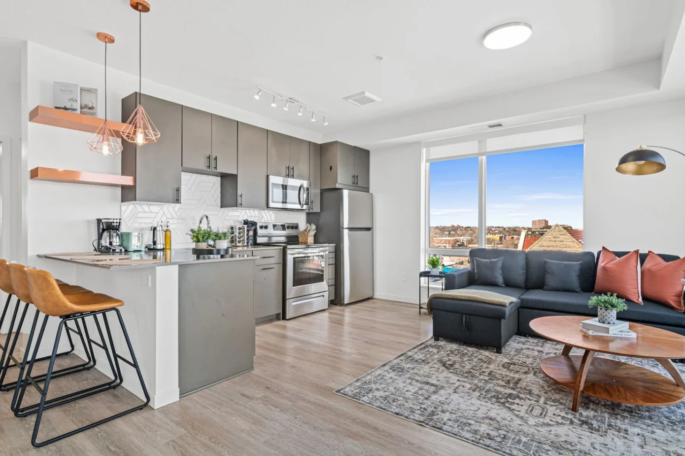 Spacious open-concept living and dining area featuring a vibrant sofa, modern furnishings, and a stylish entertainment setup—ideal for gatherings and relaxation.