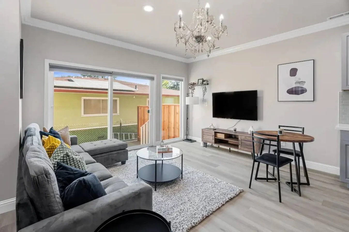 Bright and airy living room with plush seating, a large TV, and tasteful decor, creating the perfect space for relaxation and entertainment.