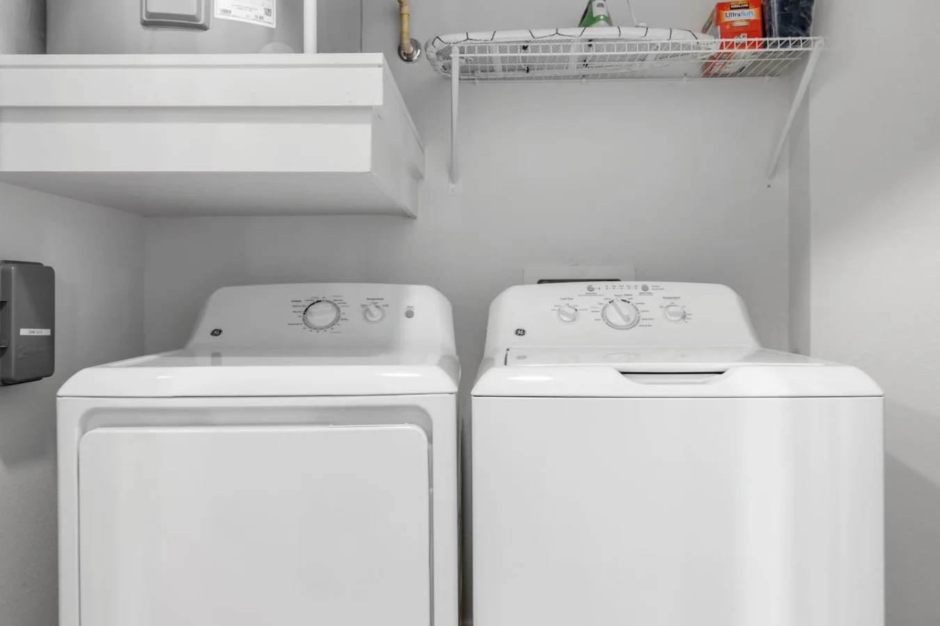 Equipped with modern machines and ample storage, this laundry room makes keeping things neat a total breeze.