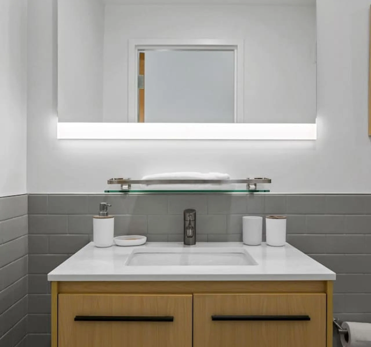 You feel a sense of calm as you enter the bathroom, where the thoughtful design and high-quality materials create a serene environment.