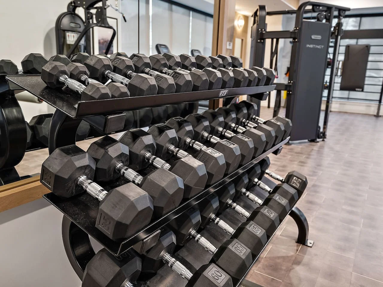 Dedicated space featuring a wide range of dumbbells, benches, and mirrors for strength and resistance training