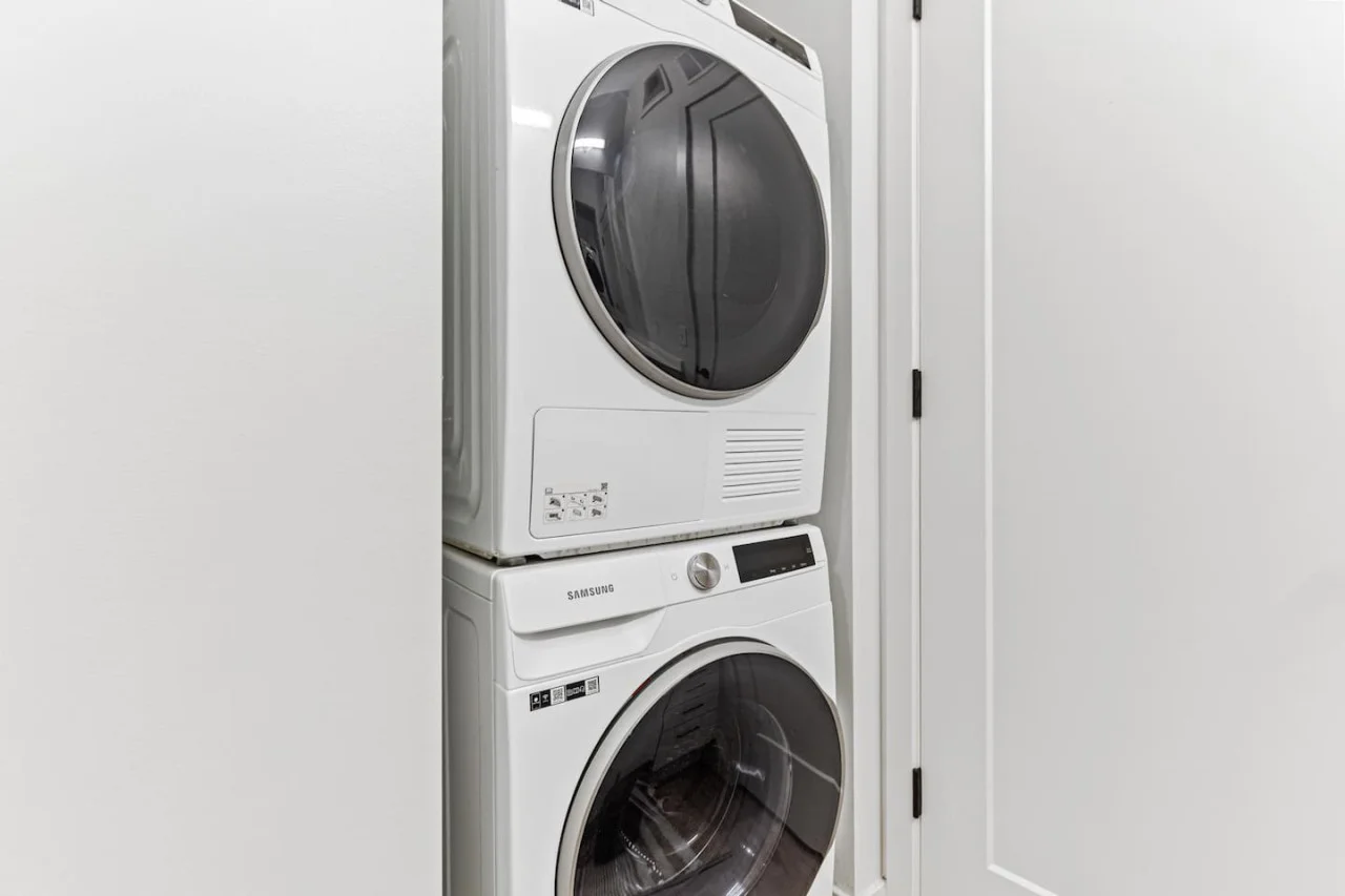 Laundry room with a washer, dryer, and folding area, offering all the convenience you need for a comfortable extended stay.