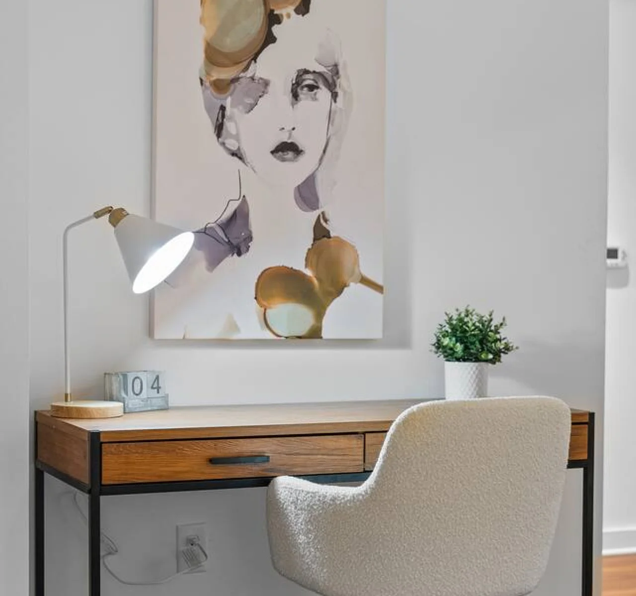 This cozy workspace with warm lighting, and a creative wall display, perfect for productivity.