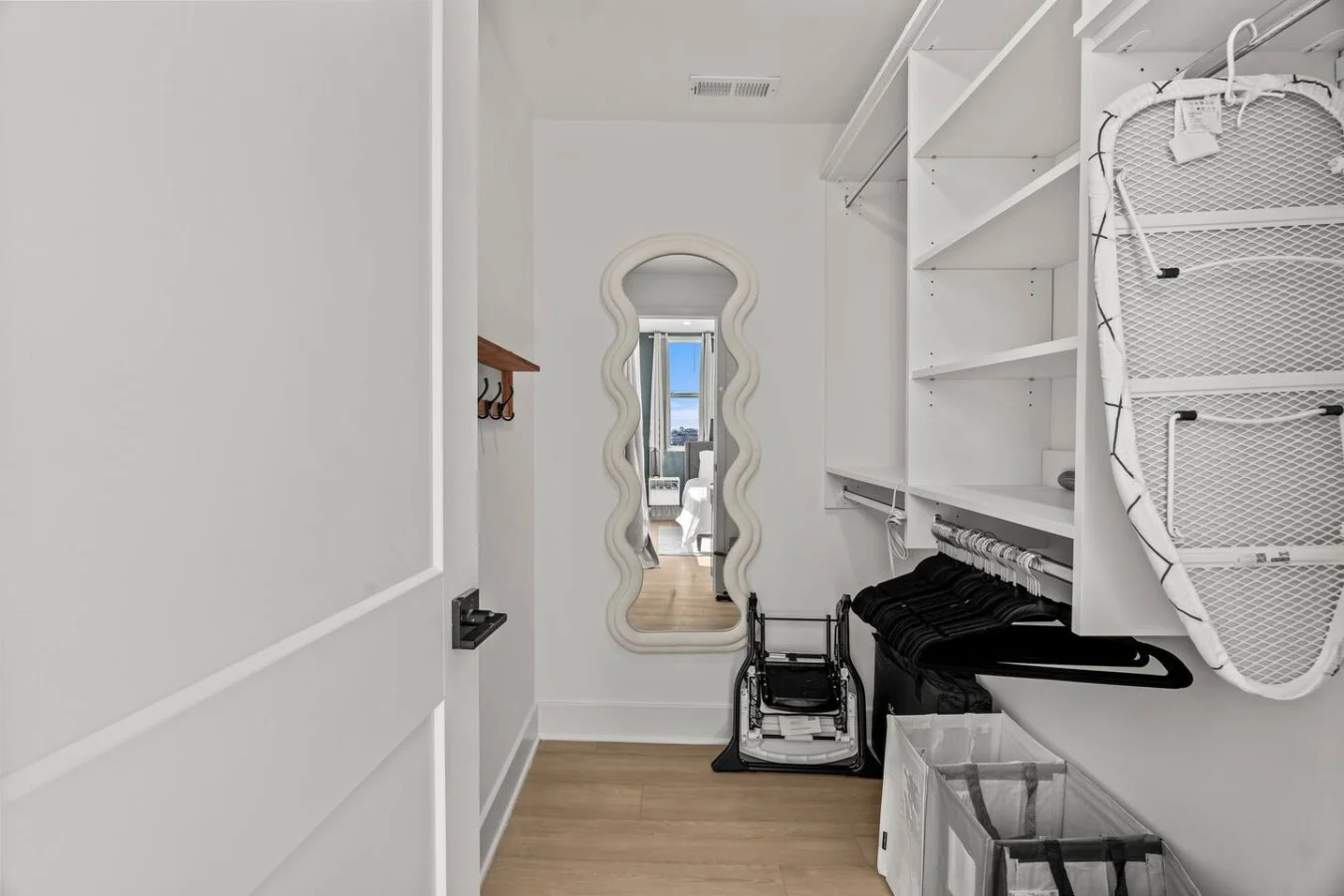Sleek closet doors hide plenty of storage space, ensuring your room remains open and tidy during your stay.